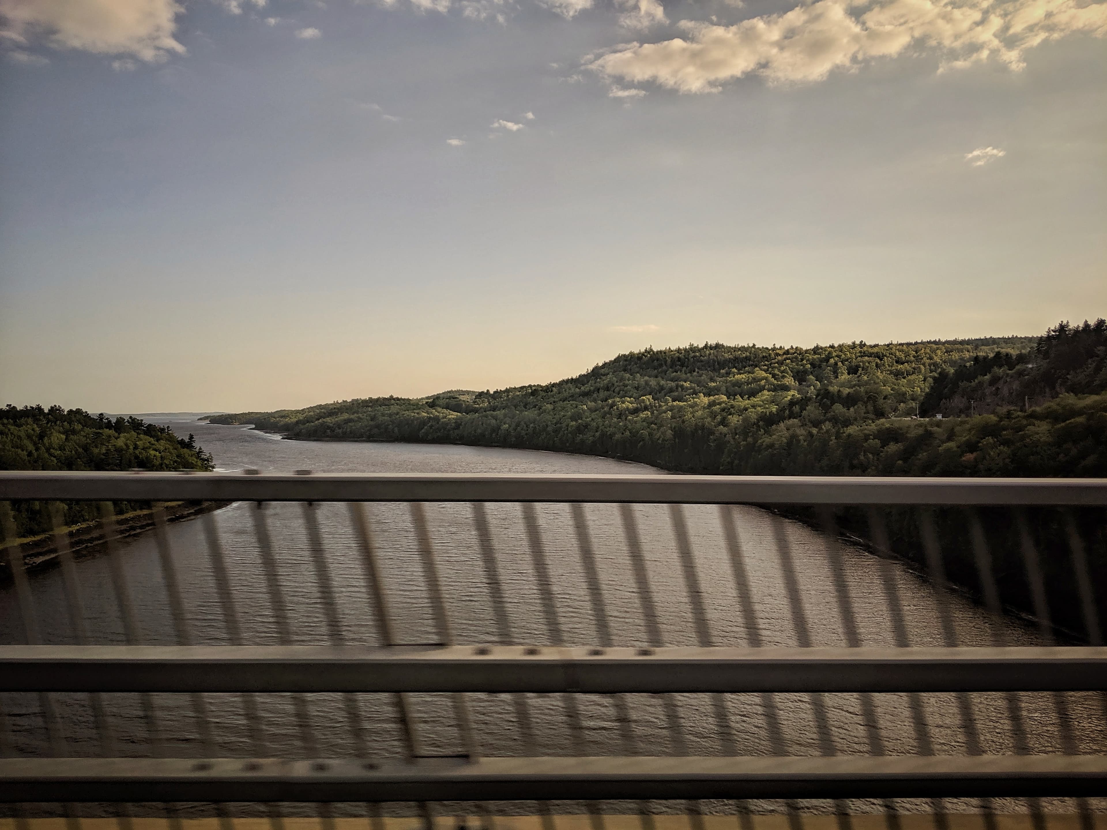 A view from a bridge above a river flowing into the ocean in Maine